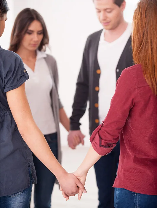 A Group Of People Holding Hands In A Circle At The Adderall Detox Centre, Symbolizing Unity And Healing.