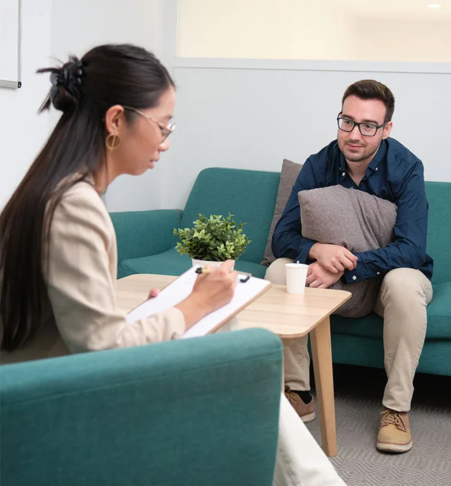 Therapist Assisting A Client Through Recovery Stages In A Detox From Heroin Session.