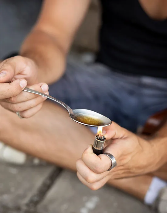 Individual Pictured With Drugs, Highlighting The Urgency Of Detox From Heroin.
