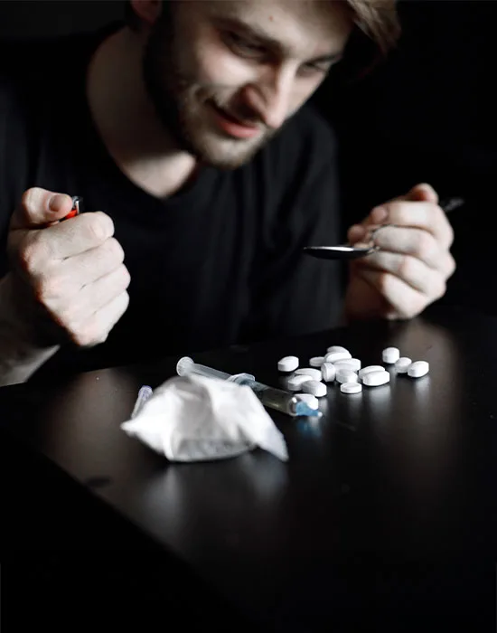 Individual Pictured With Drugs, Highlighting The Urgency Of Opioid Detox Support